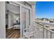 Outdoor balcony with white railing and view of the city and nearby buildings at 2801 S Ocean Blvd. # 231, North Myrtle Beach, SC 29582