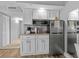 Compact kitchen with granite countertops, white cabinets, and stainless steel refrigerator at 2801 S Ocean Blvd. # 231, North Myrtle Beach, SC 29582