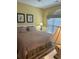 Comfortable bedroom with wood floors, two pictures on the wall, and a large window at 4639 Wild Iris Dr. # 43-204, Myrtle Beach, SC 29577