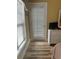 Bright bedroom with wood flooring, a white dresser, and a door to the outside at 4639 Wild Iris Dr. # 43-204, Myrtle Beach, SC 29577