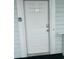White door with unit number '204' and a Primary Lock on a pale blue building at 4639 Wild Iris Dr. # 43-204, Myrtle Beach, SC 29577