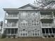 Condo exterior showcasing the light gray brick facade and multiple balconies at 4639 Wild Iris Dr. # 43-204, Myrtle Beach, SC 29577