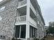 Condo's side view exhibiting multiple balconies and gray brick details at 4639 Wild Iris Dr. # 43-204, Myrtle Beach, SC 29577