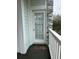 Exterior view of building featuring a door with nine glass panes and a white railing at 4639 Wild Iris Dr. # 43-204, Myrtle Beach, SC 29577
