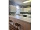 Kitchen features a breakfast bar with wicker stools, a garden window, and white cabinetry at 4639 Wild Iris Dr. # 43-204, Myrtle Beach, SC 29577