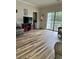 Living room showcasing the laminate floors and balcony access at 4639 Wild Iris Dr. # 43-204, Myrtle Beach, SC 29577