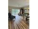 Living room features modern laminate floors, a ceiling fan, and a glass door to a balcony at 4639 Wild Iris Dr. # 43-204, Myrtle Beach, SC 29577