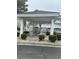 Community mailboxes under a gazebo, surrounded by manicured bushes in a residential complex at 4639 Wild Iris Dr. # 43-204, Myrtle Beach, SC 29577