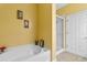 Bathroom showcasing a soaking tub and separate glass-enclosed shower with yellow walls and tile floors at 471 Deerfield Links Dr., Surfside Beach, SC 29575