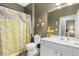 Bathroom featuring a vanity sink, toilet and tub/shower combo with decorative floral shower curtain and wall decor at 471 Deerfield Links Dr., Surfside Beach, SC 29575
