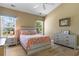 Comfortable bedroom with hardwood floors, a large window, a queen bed, and neutral decor at 471 Deerfield Links Dr., Surfside Beach, SC 29575