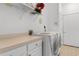 Bright laundry room equipped with modern washer and dryer, counter space, and ample storage for supplies at 471 Deerfield Links Dr., Surfside Beach, SC 29575