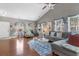 Bright living room featuring hardwood floors, vaulted ceilings, a comfortable sofa, and lots of natural light at 471 Deerfield Links Dr., Surfside Beach, SC 29575
