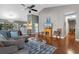Open-concept living area with hardwood floors, a cozy fireplace, comfortable furniture, and views into the kitchen at 471 Deerfield Links Dr., Surfside Beach, SC 29575