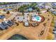 Aerial view of a pristine community pool, tennis court, playground, and immaculate landscaping at 5606 Whitebark Dr., Myrtle Beach, SC 29577
