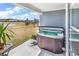 Covered porch area features a hot tub and outdoor seating with a lake view at 5606 Whitebark Dr., Myrtle Beach, SC 29577