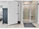 Bright bathroom features a tile shower, a decorative door, and a gray tile floor at 5606 Whitebark Dr., Myrtle Beach, SC 29577