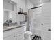 Bright bathroom featuring a white vanity, granite countertop, tub/shower and a decorative wall shelf at 5606 Whitebark Dr., Myrtle Beach, SC 29577