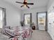Bright bedroom features a ceiling fan, neutral walls, carpet and two large windows at 5606 Whitebark Dr., Myrtle Beach, SC 29577