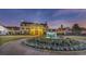 Beautiful clubhouse with a fountain and manicured landscaping at dusk at 5606 Whitebark Dr., Myrtle Beach, SC 29577