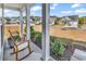 Inviting front porch with rocking chairs and lush landscaping, providing a relaxing outdoor space at 5606 Whitebark Dr., Myrtle Beach, SC 29577