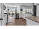 Well-lit kitchen featuring white cabinets, stainless steel appliances, and an adjacent dining area at 5606 Whitebark Dr., Myrtle Beach, SC 29577