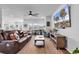 Spacious living room with a large TV, ceiling fan, comfortable seating, and plenty of natural light at 5606 Whitebark Dr., Myrtle Beach, SC 29577