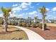 Well maintained community playground area surrounded by mature landscaping and palm trees at 5606 Whitebark Dr., Myrtle Beach, SC 29577