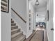 Carpeted staircase with wood railing leads to the upper level, illuminated by a stylish pendant light at 5606 Whitebark Dr., Myrtle Beach, SC 29577