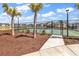 Well maintained community tennis court surrounded by palm trees and landscaping at 5606 Whitebark Dr., Myrtle Beach, SC 29577