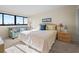 Bright bedroom with a window view, blue couch, and nautical-themed decorations at 601 Mitchell Dr. # 801, Myrtle Beach, SC 29577