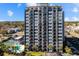 Aerial view of the high-rise condo building, showcasing the pool, tennis courts, and ample parking at 601 Mitchell Dr. # 801, Myrtle Beach, SC 29577