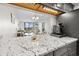 Modern kitchen with granite counters open to the dining and living areas, with stainless appliance at 601 Mitchell Dr. # 801, Myrtle Beach, SC 29577