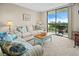 Bright living room with balcony access featuring city views, comfortable seating and stylish decor at 601 Mitchell Dr. # 801, Myrtle Beach, SC 29577