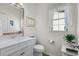 Well-lit bathroom featuring a vanity, a sink, a window with natural light, and neutral colors at 100 Marblehead Dr., Little River, SC 29566