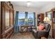 Cozy den with hardwood floors, built-in shelving, and water views at 100 Marblehead Dr., Little River, SC 29566