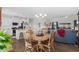 Open concept dining area featuring a wood table, chairs, chandelier and view of the living room at 100 Marblehead Dr., Little River, SC 29566