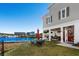 Relaxing outdoor patio with waterfront views, lounge seating, and red patio umbrella at 100 Marblehead Dr., Little River, SC 29566