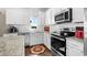 Efficient kitchen featuring stainless steel appliances, white cabinets, and granite countertops and white subway tile backsplash at 100 Marblehead Dr., Little River, SC 29566