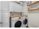 Laundry room with a washer, dryer, wood countertops, and built-in storage at 100 Marblehead Dr., Little River, SC 29566