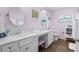 Main bathroom featuring double sinks, white cabinets, granite counters, vanity area and decorative mirrors at 100 Marblehead Dr., Little River, SC 29566
