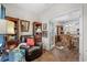 Sitting area with leather chair, bookshelves, and view of the kitchen and dining area through glass doors at 100 Marblehead Dr., Little River, SC 29566