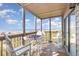Inviting screened-in porch with outdoor seating and a game table with ocean views at 108 Ocean Blvd. N # 101, North Myrtle Beach, SC 29582