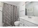 Bathroom featuring a white vanity with grey floral shower curtain at 108 Ocean Blvd. N # 101, North Myrtle Beach, SC 29582