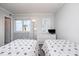 Cozy bedroom with twin beds, nautical decor, and a window view of the beach at 108 Ocean Blvd. N # 101, North Myrtle Beach, SC 29582