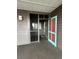 Condo entrance featuring a colorful door and screened-in porch, offering a welcoming appeal at 108 Ocean Blvd. N # 101, North Myrtle Beach, SC 29582