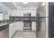 Modern kitchen features sleek appliances, white cabinets, and granite countertops at 108 Ocean Blvd. N # 101, North Myrtle Beach, SC 29582