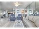 Comfortable living room featuring a mirrored wall, bright interiors, and tile floors at 108 Ocean Blvd. N # 101, North Myrtle Beach, SC 29582