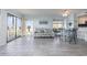 Open-concept living space with tile floors, comfortable seating, and balcony access at 108 Ocean Blvd. N # 101, North Myrtle Beach, SC 29582