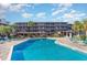 A refreshing outdoor pool is surrounded by lounge chairs and lush landscaping at 108 Ocean Blvd. N # 101, North Myrtle Beach, SC 29582